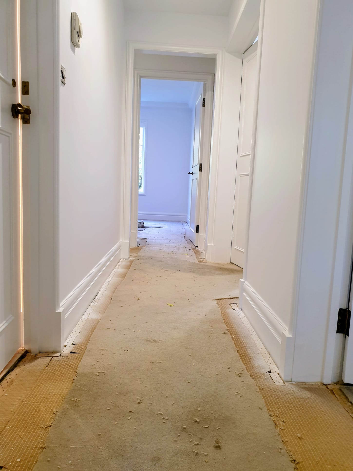 Toorak hallway with fresh white walls and detailed trim