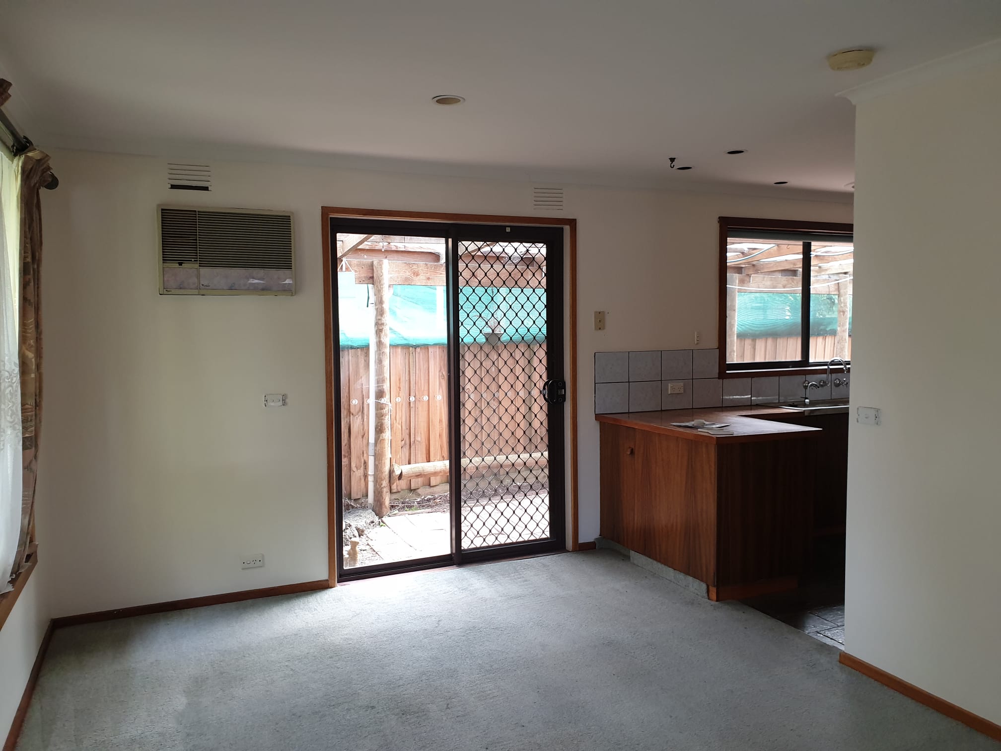 Repainted walls and ceiling beside a kitchen