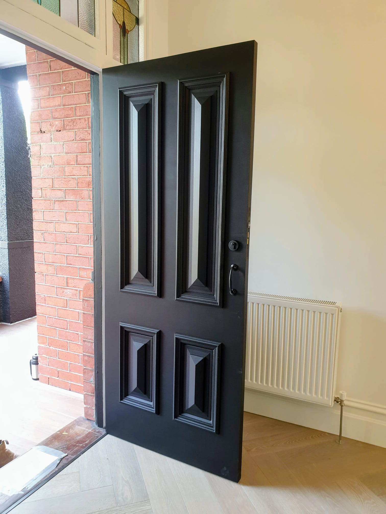 Dark feature front door with freshly painted trim