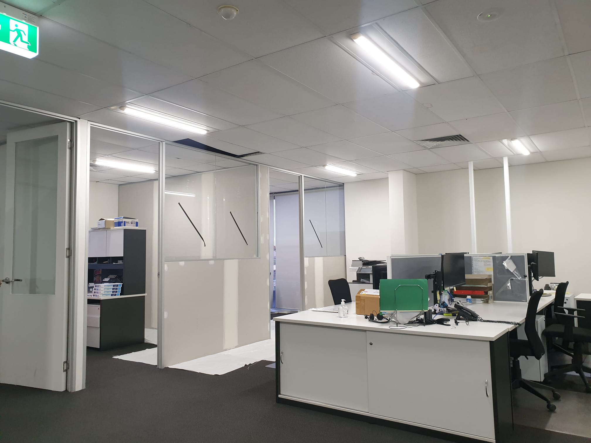 Office interior with freshly painted walls and protected work areas