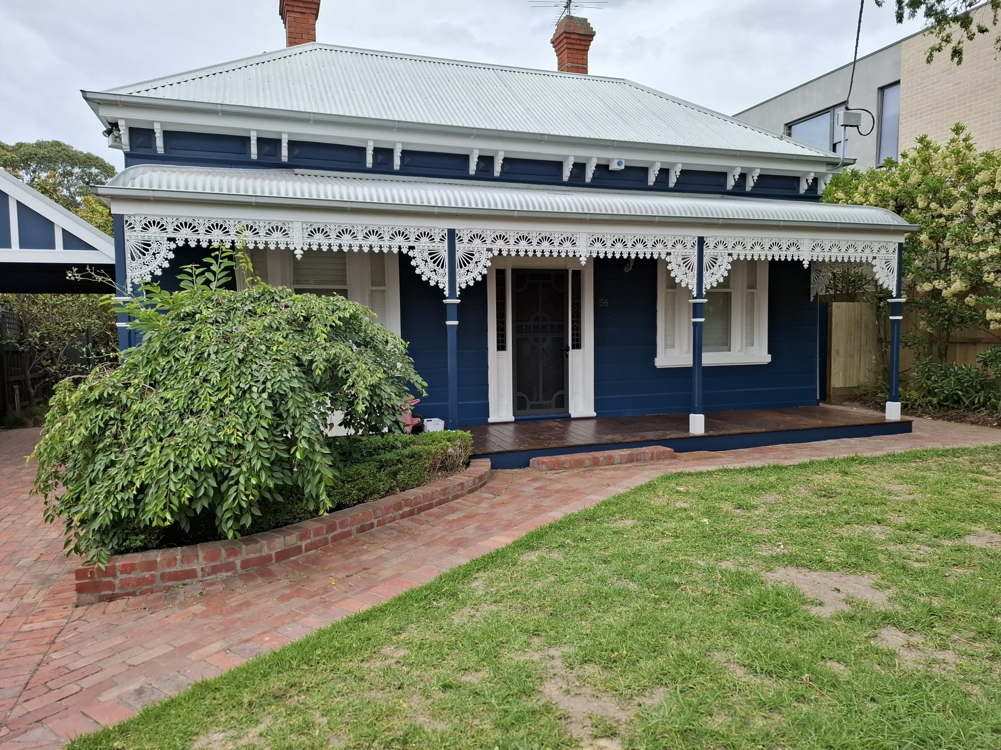 Painted heritage home exterior with contrasting weatherboards and trim